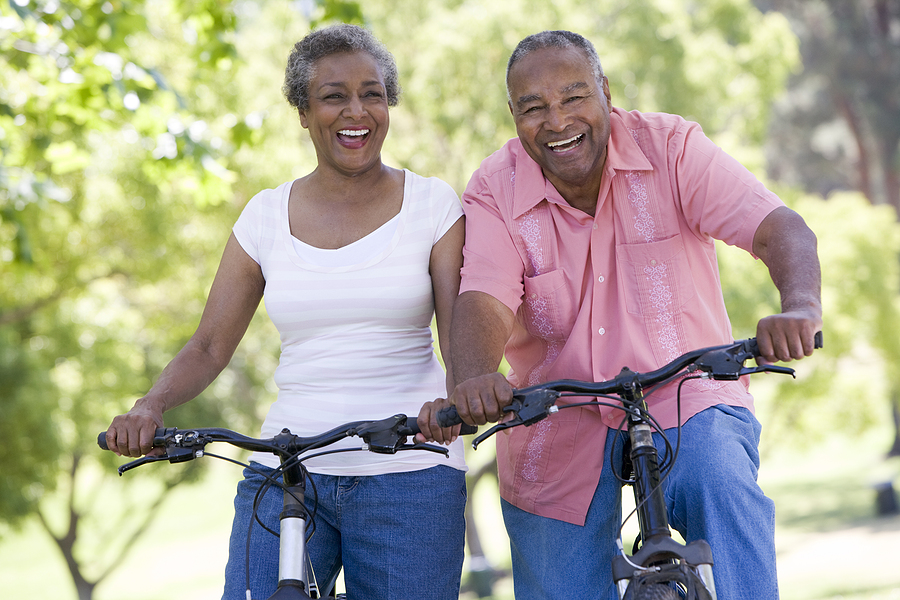 A bicycling couple demonstrating a healthy lifestyle for senior