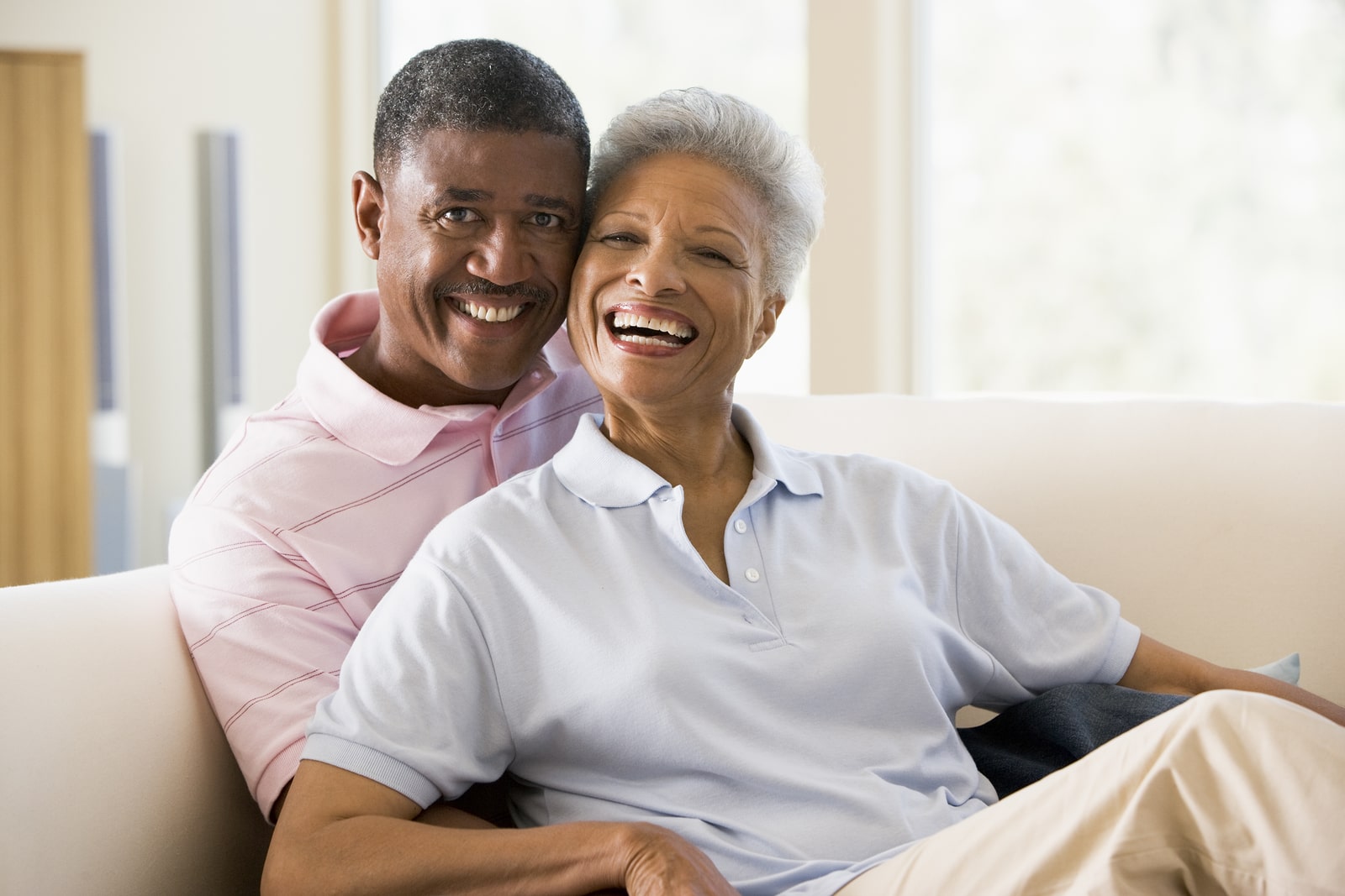 Happy senior couple feeling safe in their home.