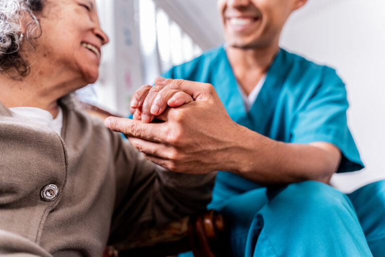 Staff helping senior resident